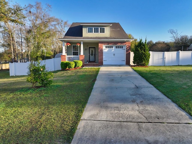 view of front of property with brick siding, fence, a front yard, covered porch, and driveway