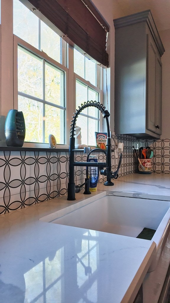 details featuring gray cabinetry, light countertops, and a sink