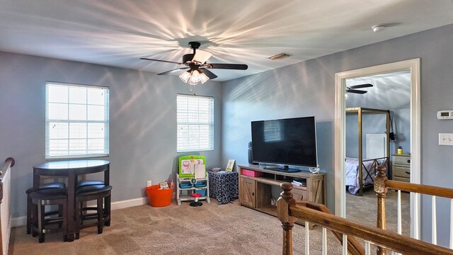 rec room featuring visible vents, baseboards, a ceiling fan, and carpet floors