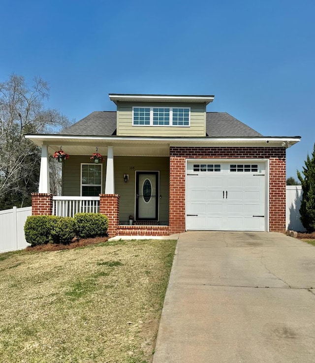 view of front facade featuring a front yard, fence, covered porch, concrete driveway, and a garage