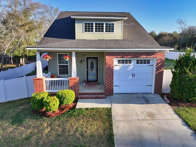 view of front of property with brick siding, fence, concrete driveway, covered porch, and an attached garage