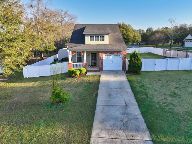 view of front facade featuring a front yard, fence, driveway, covered porch, and brick siding