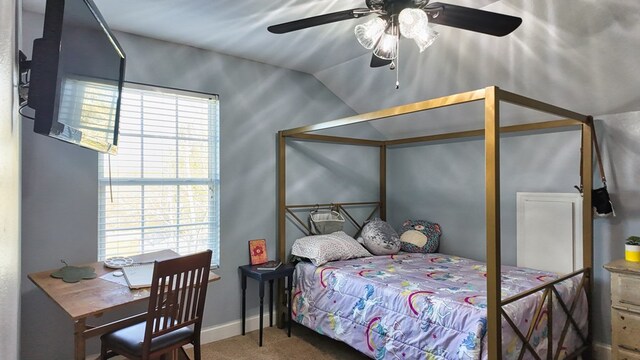 bedroom featuring a ceiling fan, lofted ceiling, carpet, and baseboards