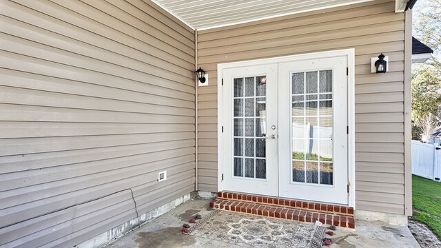 entrance to property with french doors and fence