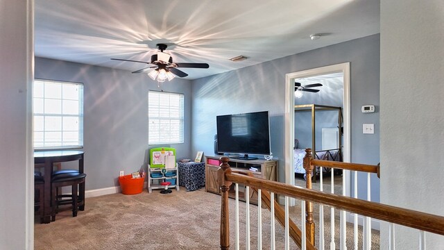 game room with carpet flooring, ceiling fan, baseboards, and visible vents