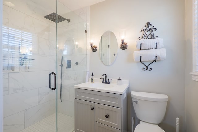 bathroom with toilet, a stall shower, and vanity