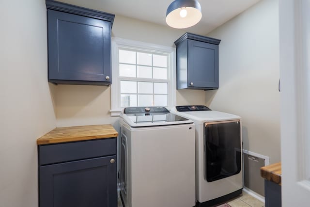 washroom featuring washing machine and dryer and cabinet space