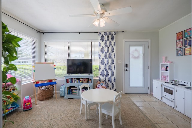 living area featuring light tile patterned flooring and ceiling fan