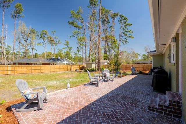 view of patio featuring an outbuilding, a fenced backyard, and a shed