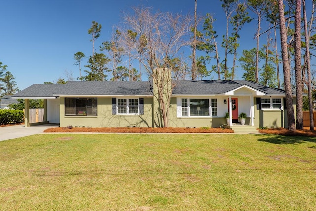 ranch-style house featuring driveway, an attached carport, and a front yard