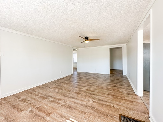 unfurnished room featuring ceiling fan, ornamental molding, a textured ceiling, and light hardwood / wood-style flooring