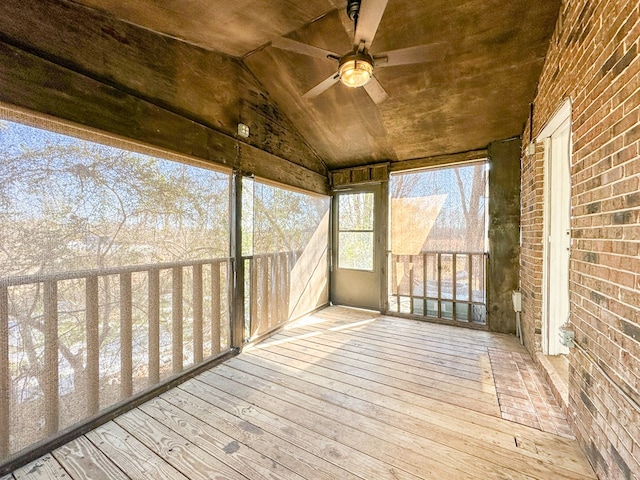 unfurnished sunroom featuring ceiling fan, vaulted ceiling, and wooden ceiling