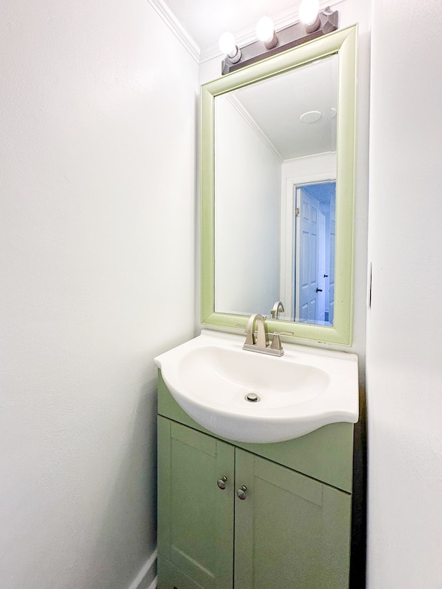 bathroom with ornamental molding and vanity