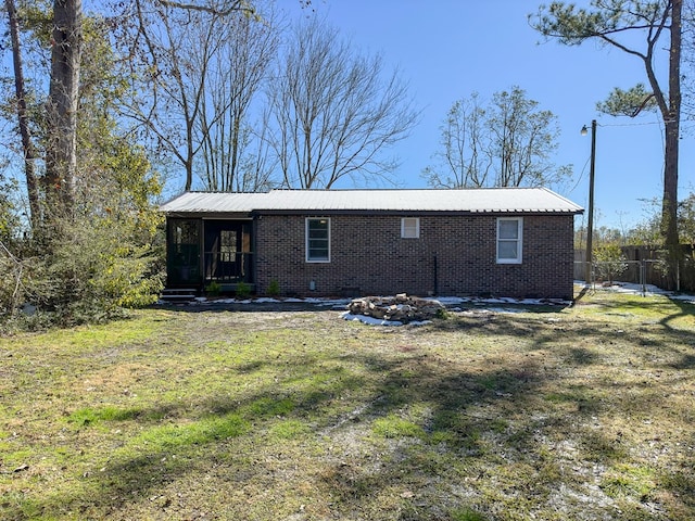 back of property featuring a lawn