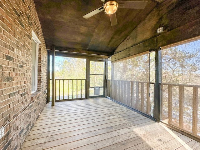 unfurnished sunroom with ceiling fan