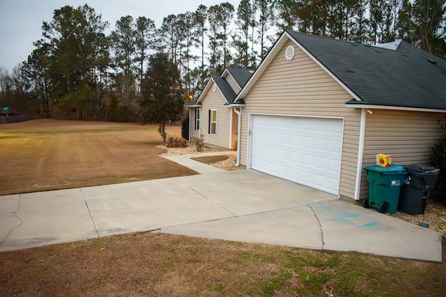 view of front of house featuring a garage and a front lawn