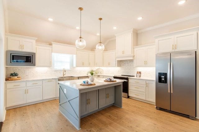 kitchen featuring white cabinets, decorative light fixtures, light hardwood / wood-style floors, and appliances with stainless steel finishes