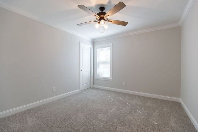 unfurnished room featuring carpet, ceiling fan, and crown molding