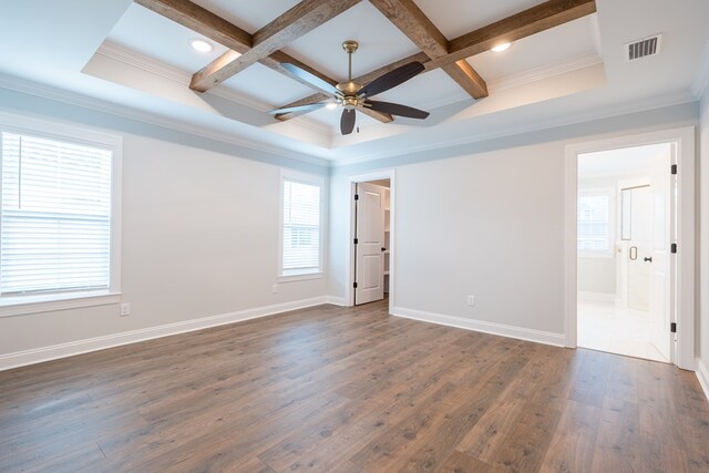 empty room with coffered ceiling, ceiling fan, dark wood-type flooring, crown molding, and beam ceiling