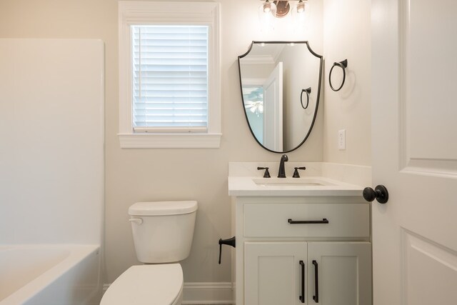 bathroom featuring a bathtub, vanity, and toilet