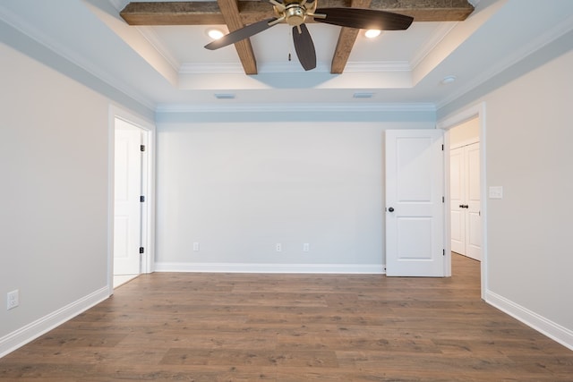 spare room featuring beamed ceiling, dark hardwood / wood-style flooring, ceiling fan, and crown molding