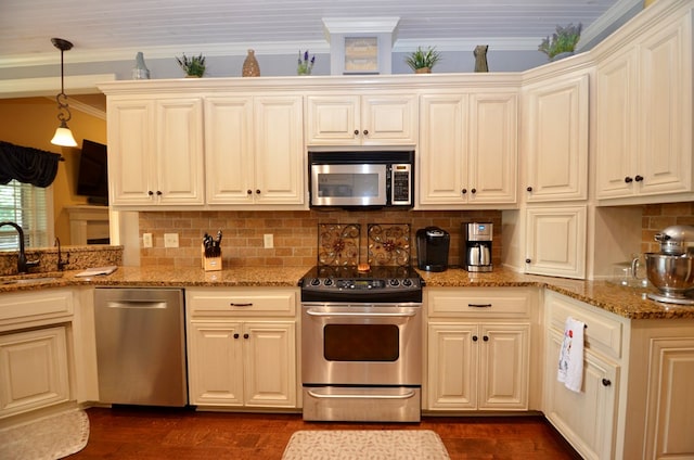 3854 Orchard Way, Valdosta, GA 31605 - kitchen with appliances with stainless steel finishes, a sink, dark wood finished floors, crown molding, and tasteful backsplash