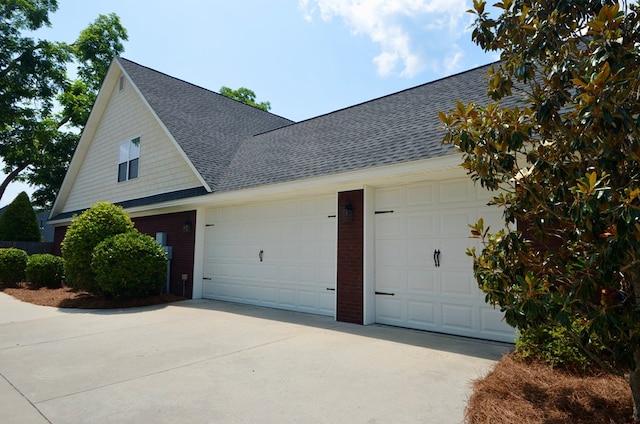 3854 Orchard Way, Valdosta, GA 31605 - view of home's exterior featuring a shingled roof, brick siding, a garage, and concrete driveway