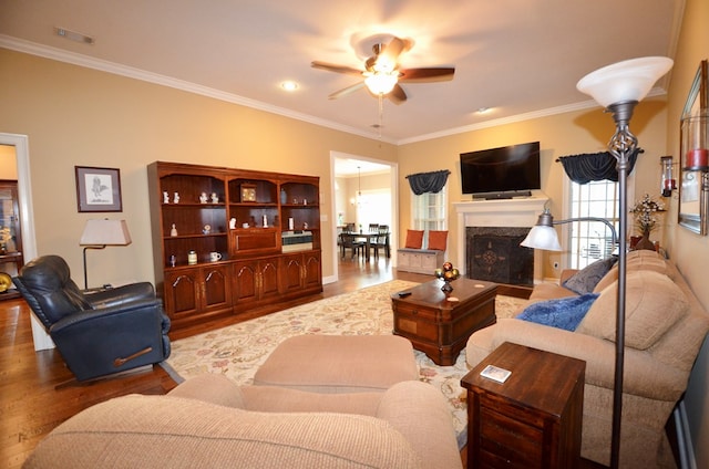 3854 Orchard Way, Valdosta, GA 31605 - living area featuring wood finished floors, crown molding, a ceiling fan, and a fireplace