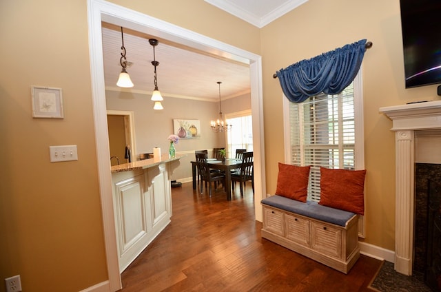 3854 Orchard Way, Valdosta, GA 31605 - kitchen with dark wood-style flooring, ornamental molding, a chandelier, pendant lighting, and baseboards