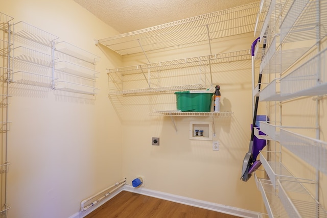 laundry area featuring washer hookup, electric dryer hookup, and hardwood / wood-style floors