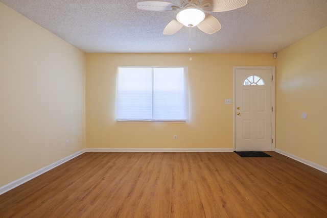 entrance foyer featuring ceiling fan, a textured ceiling, and hardwood / wood-style flooring