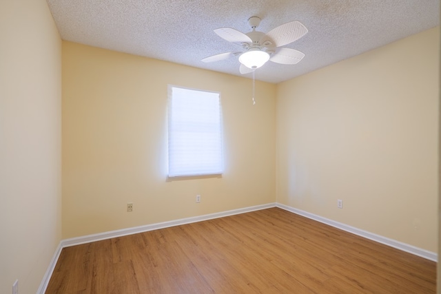 unfurnished room with ceiling fan, a textured ceiling, and light hardwood / wood-style flooring