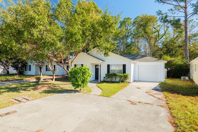 view of front of house with a garage, a front lawn, and central air condition unit