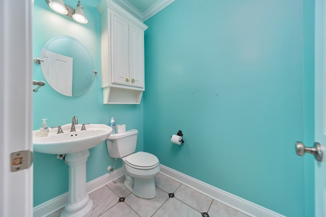 bathroom featuring toilet, tile patterned floors, crown molding, and sink