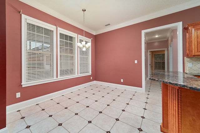 unfurnished dining area with crown molding and a chandelier