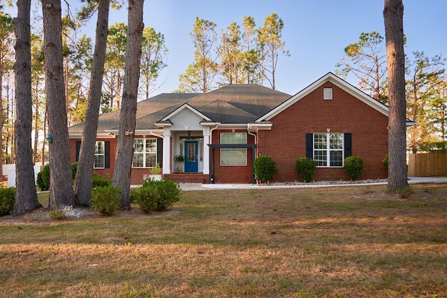 single story home featuring a front lawn