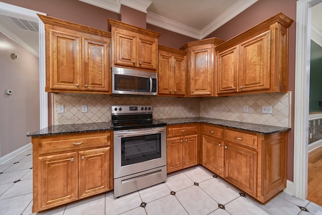 kitchen with backsplash, dark stone counters, and appliances with stainless steel finishes