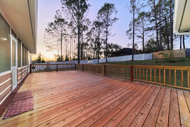 deck at dusk with a lawn