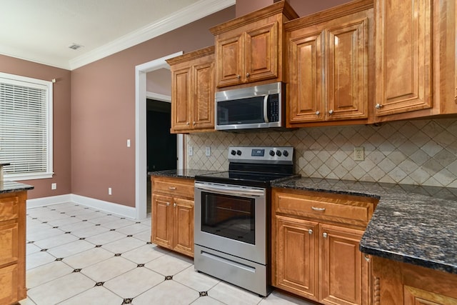 kitchen with backsplash, stainless steel appliances, ornamental molding, and dark stone countertops