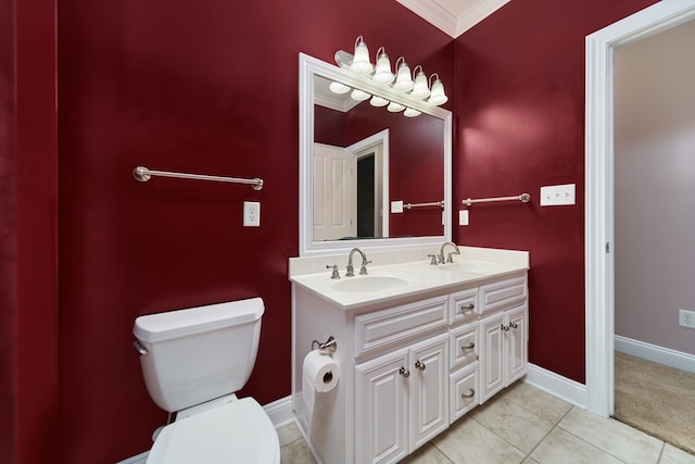 bathroom featuring tile patterned flooring, vanity, toilet, and crown molding