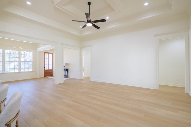 unfurnished living room with crown molding, light wood-type flooring, a raised ceiling, and ceiling fan with notable chandelier