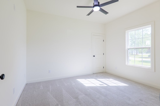 spare room featuring ceiling fan, baseboards, and carpet