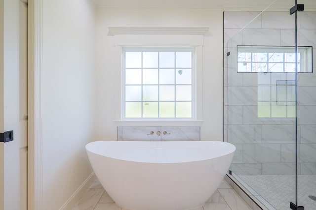 full bathroom with a soaking tub, a wealth of natural light, marble finish floor, and a stall shower
