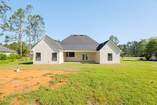rear view of property with french doors, a yard, and a patio area