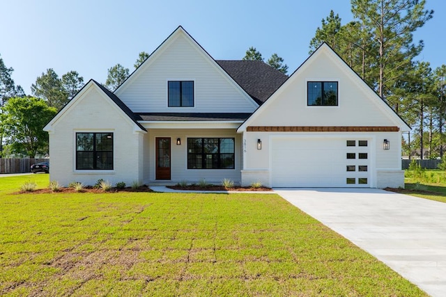 modern farmhouse style home featuring a front lawn, fence, and concrete driveway