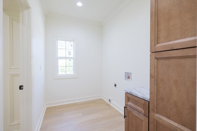 laundry area featuring hookup for an electric dryer, ornamental molding, light wood-style flooring, washer hookup, and cabinet space