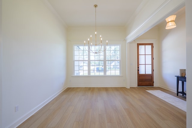 unfurnished dining area featuring crown molding, baseboards, a chandelier, and light wood-style floors
