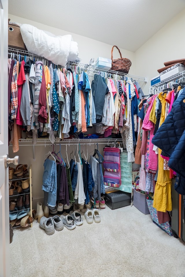 walk in closet featuring carpet floors