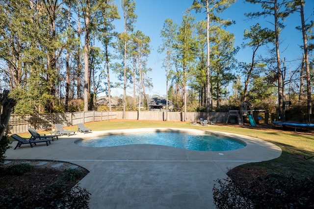 view of pool with a playground, a trampoline, a patio area, and a lawn