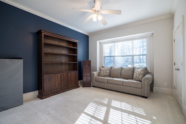 carpeted living room with ceiling fan and ornamental molding